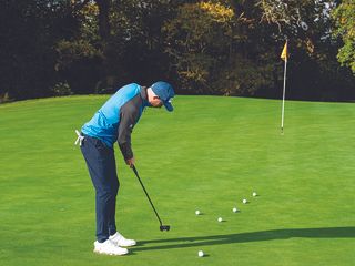 Adam Harnett demonstrating a drill for putting on slow greens