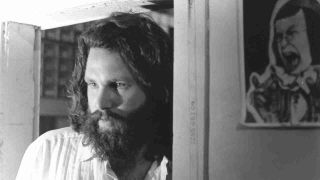 Jim Morrison of The Doors posing for a photograph at home in the Hollywood Hills in 1969