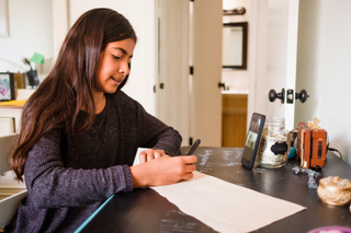 girl studying from home with phone