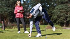 Male and female golfer on the tee