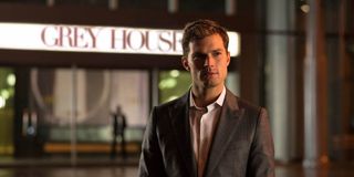 Christian Grey (Jamie Dornan) stands outside of Grey House