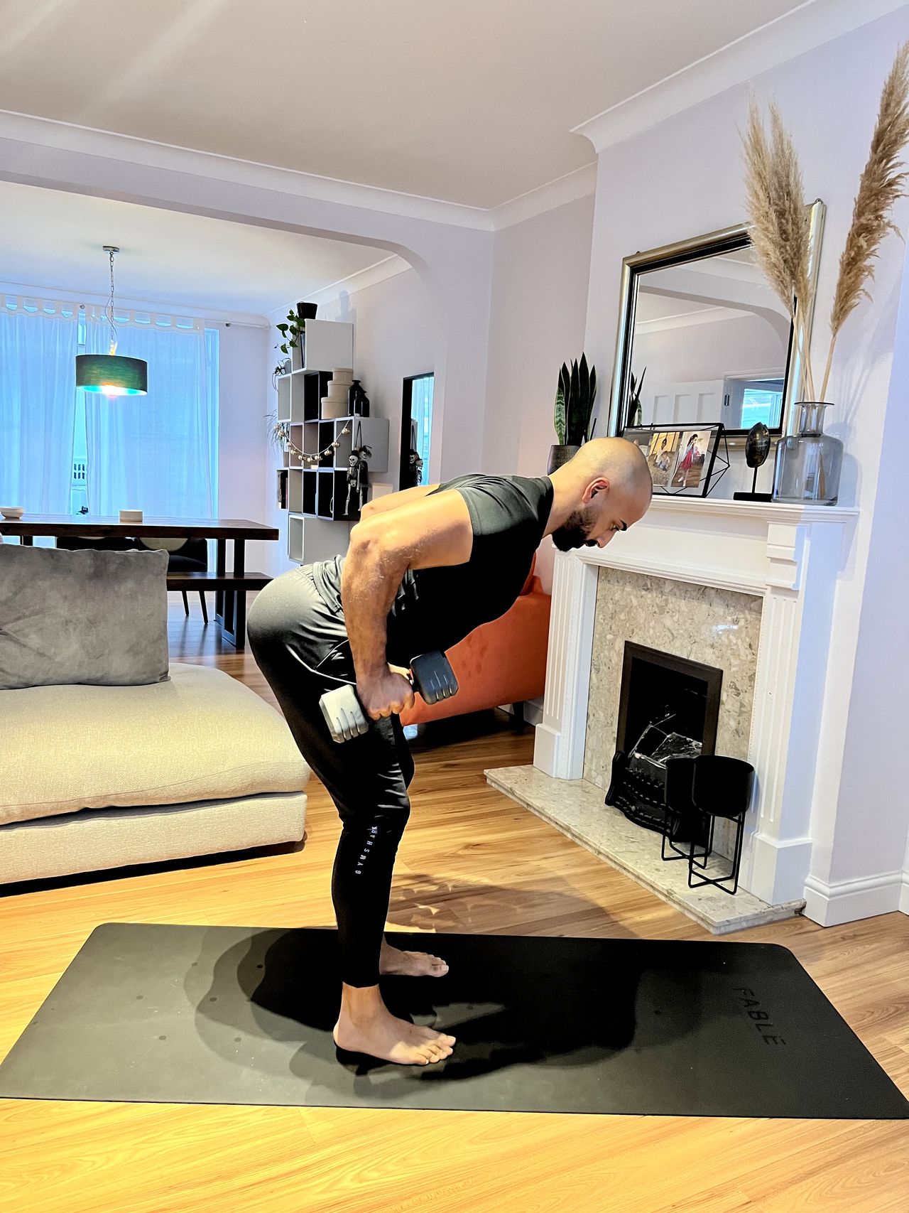 Personal trainer Ali Malik demonstrating the dumbbell bent-over row