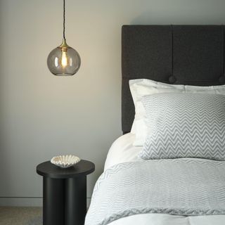 bed with a pendant light