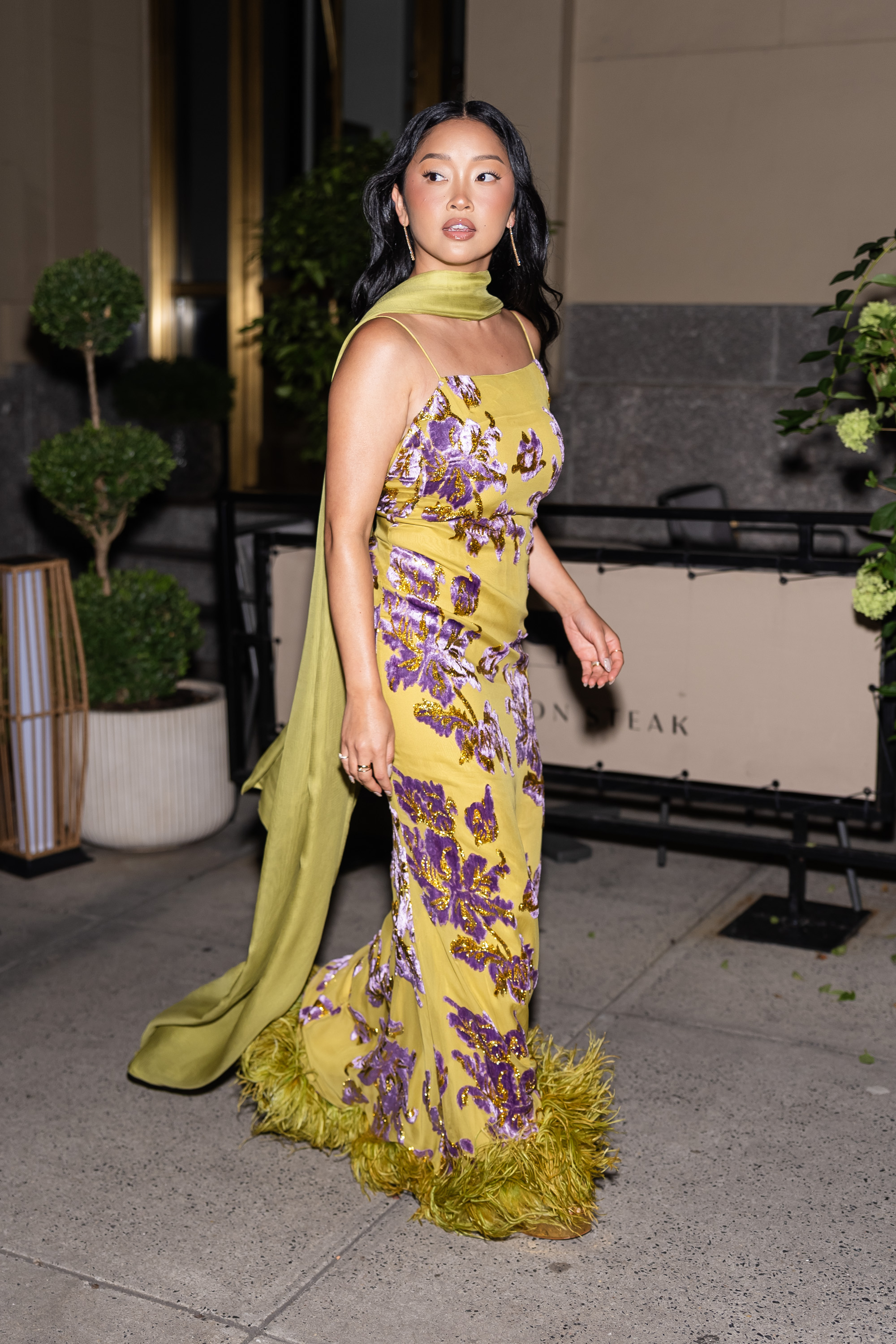 Lana Condor was spotted in NYC wearing the perfect wedding guest dress in moss green and lilac purple