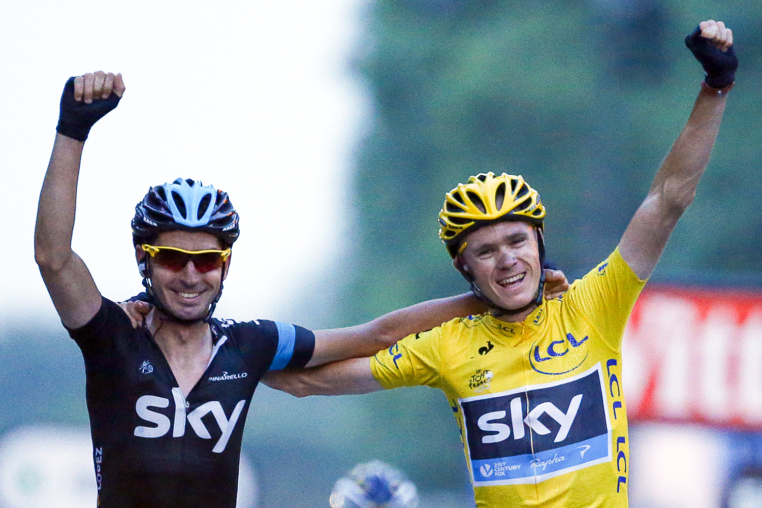 Tour de France 2013 winner Britain's Christopher Froome (R) celebrates with team mate Spain's David Lopez Garcia on the Champs-Elysees avenue in Paris, after crossing the finish line of the 133.5 km twenty-first and last stage of the 100th edition of the Tour de France cycling race on July 21, 2013 between Versailles and Paris. AFP PHOTO / PASCAL GUYOT (Photo credit should read PASCAL GUYOT/AFP via Getty Images)