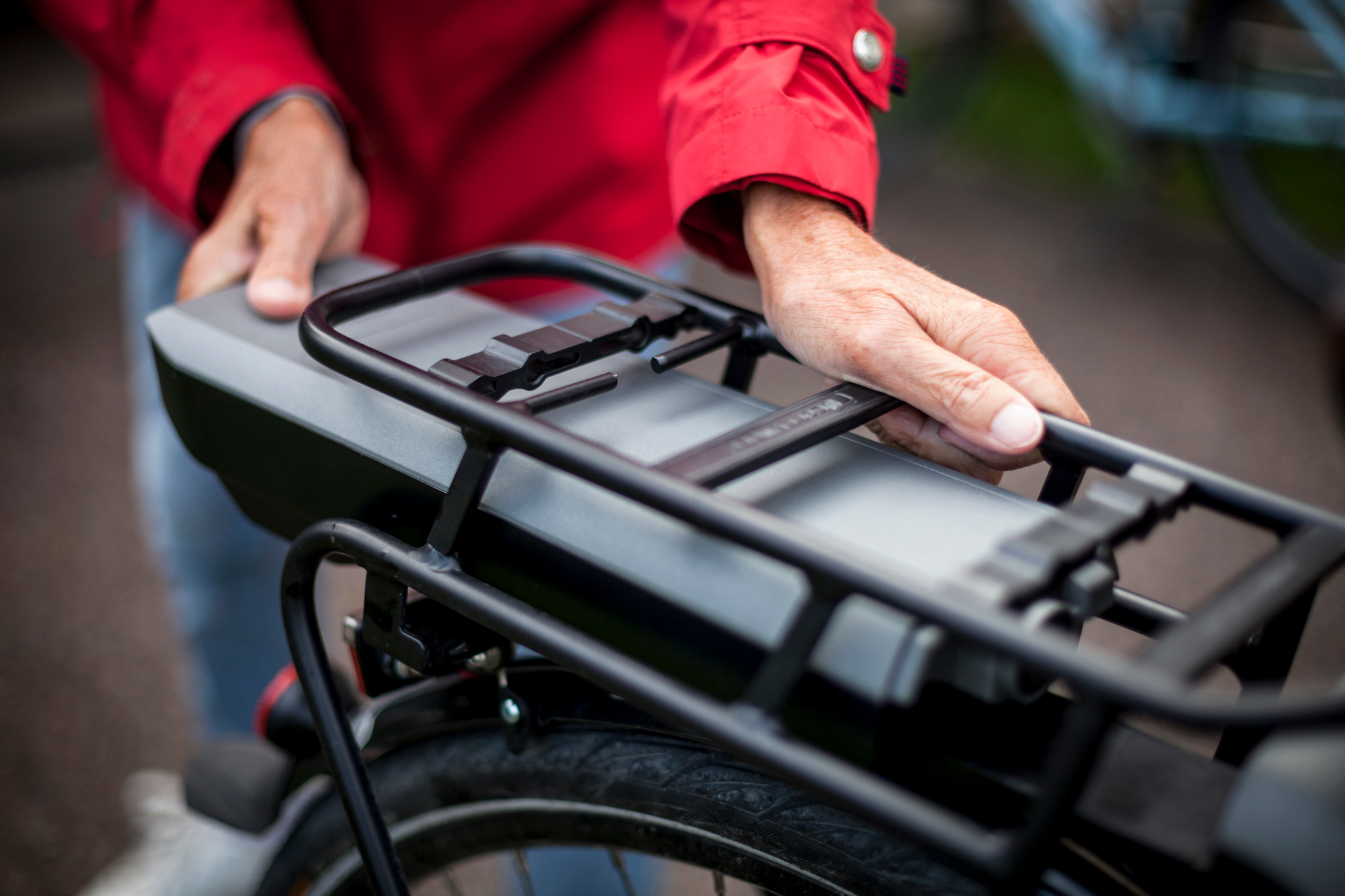 Cyclist removing the battery on their electric bike