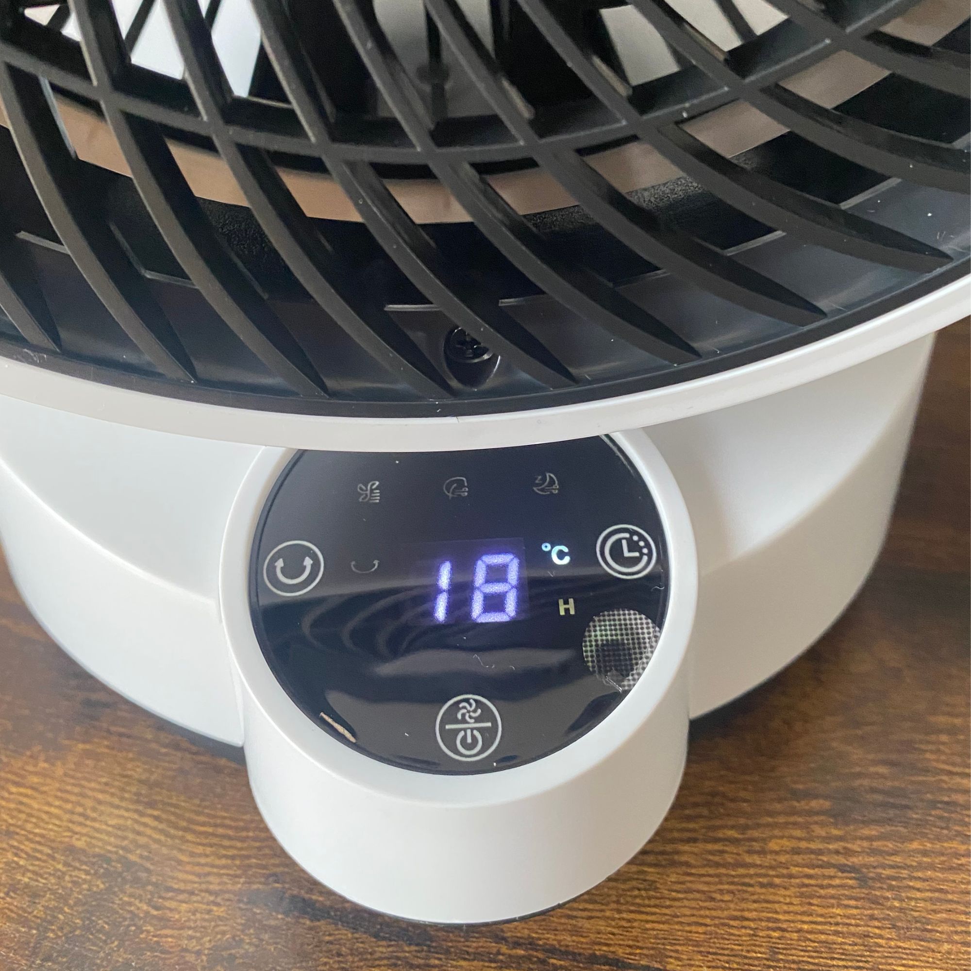 Close up of the display and on-board control panel of the Vonhaus Air Circulator Cooling Fan on a wooden surface