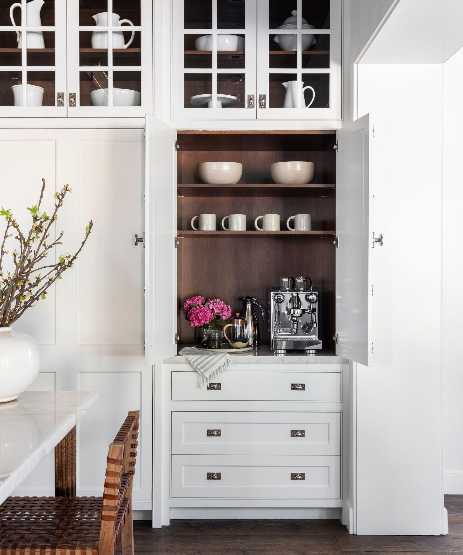 A white kitchen with a coffee bar created in an unused cabinet