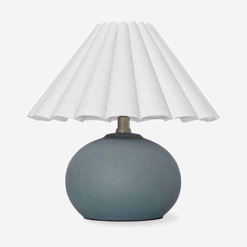 table lamp with muted blue rounded base and white pleated shade
