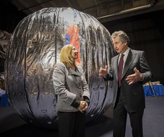 NASA Deputy Administrator Lori Garver and Robert Bigelow, founder of Bigelow Aerospace, talk while standing next to the Bigelow Expandable Activity Module on Jan. 16, 2013, in Las Vegas, Nevada.