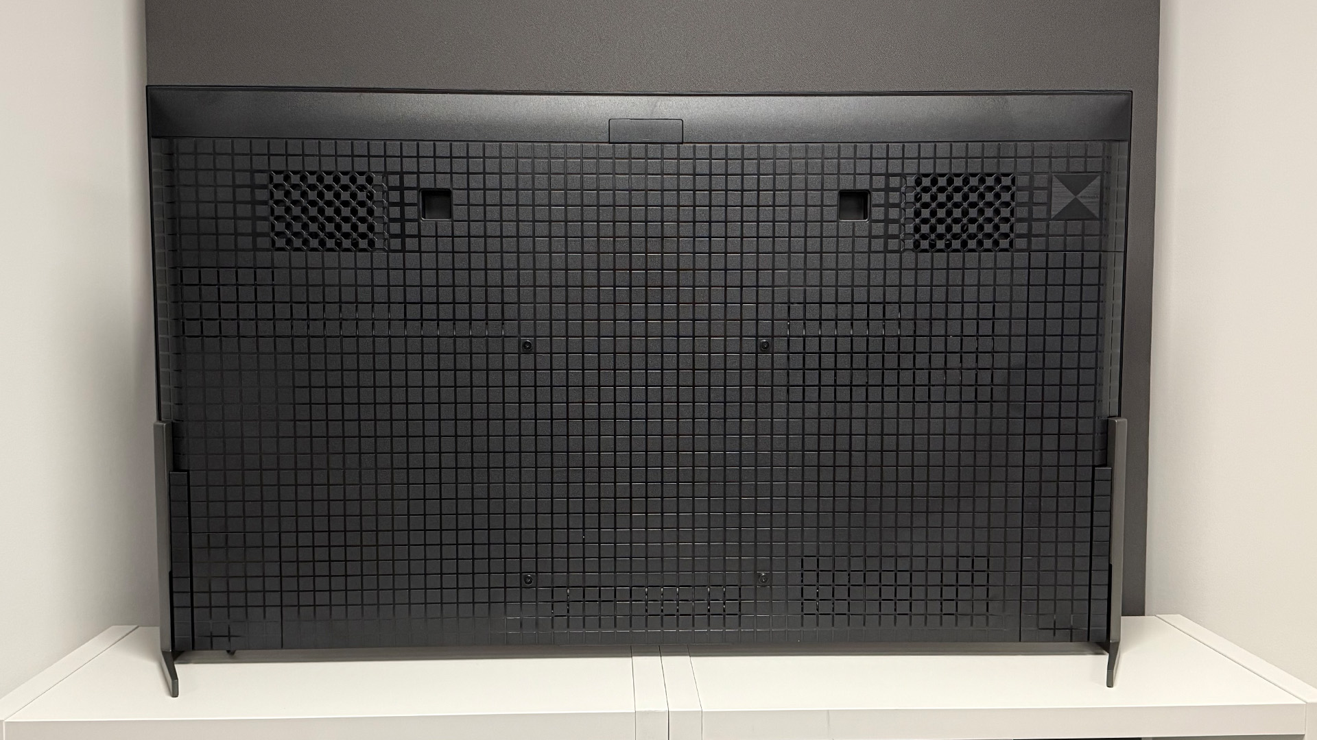 The 55-inch Sony Bravia 8 II QD-OLED TV photographed on a white table. On the screen is a nature documentary.