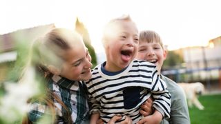 Child with Down Syndrome and siblings