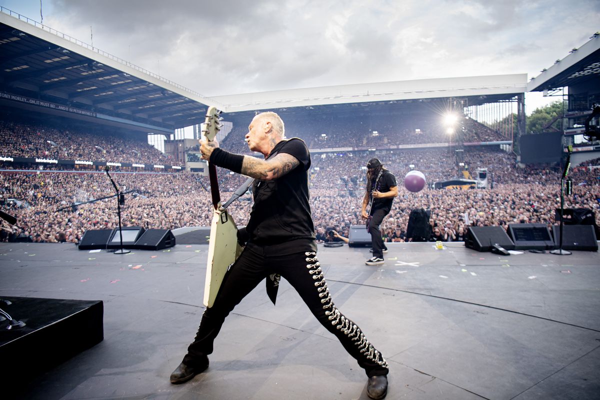 James Hetfield swinging his guitar around on stage