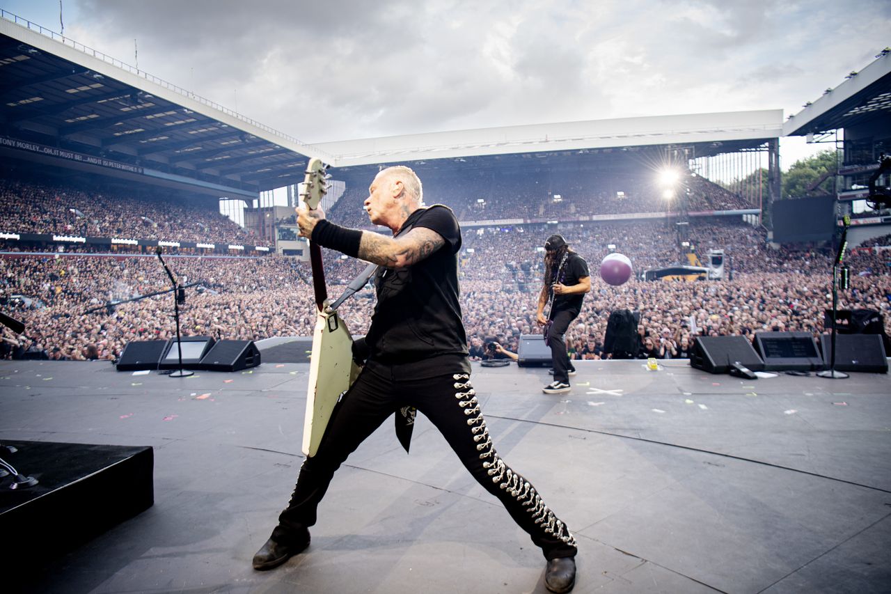 James Hetfield swinging his guitar around on stage