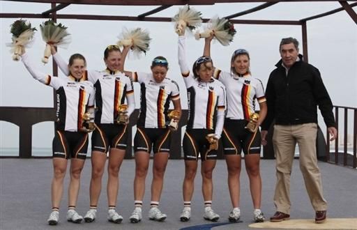 The German squad is presented with the best team prize by Eddy Merckx.