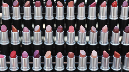 Rows of lipsticks lined up at a beauty counter