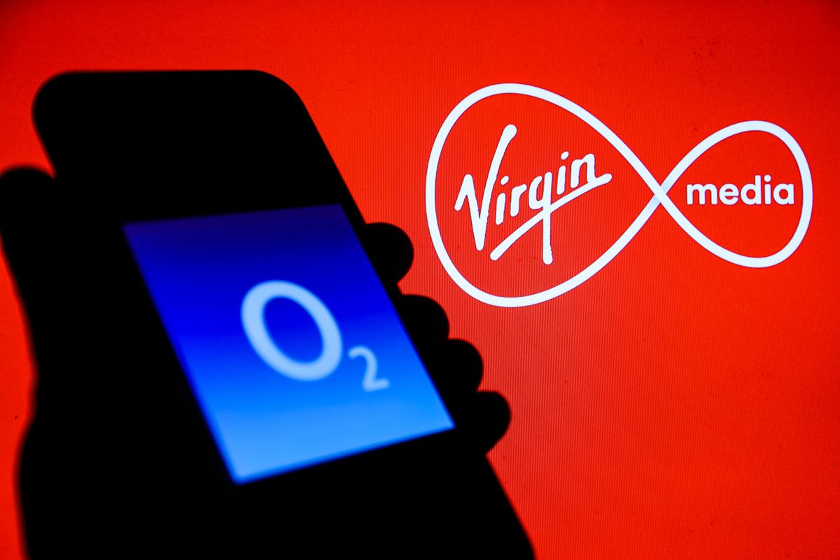 Virgin Media O2 logos: O2&#039;s is on a phone screen and Virgin Media&#039;s logo is displayed on the background