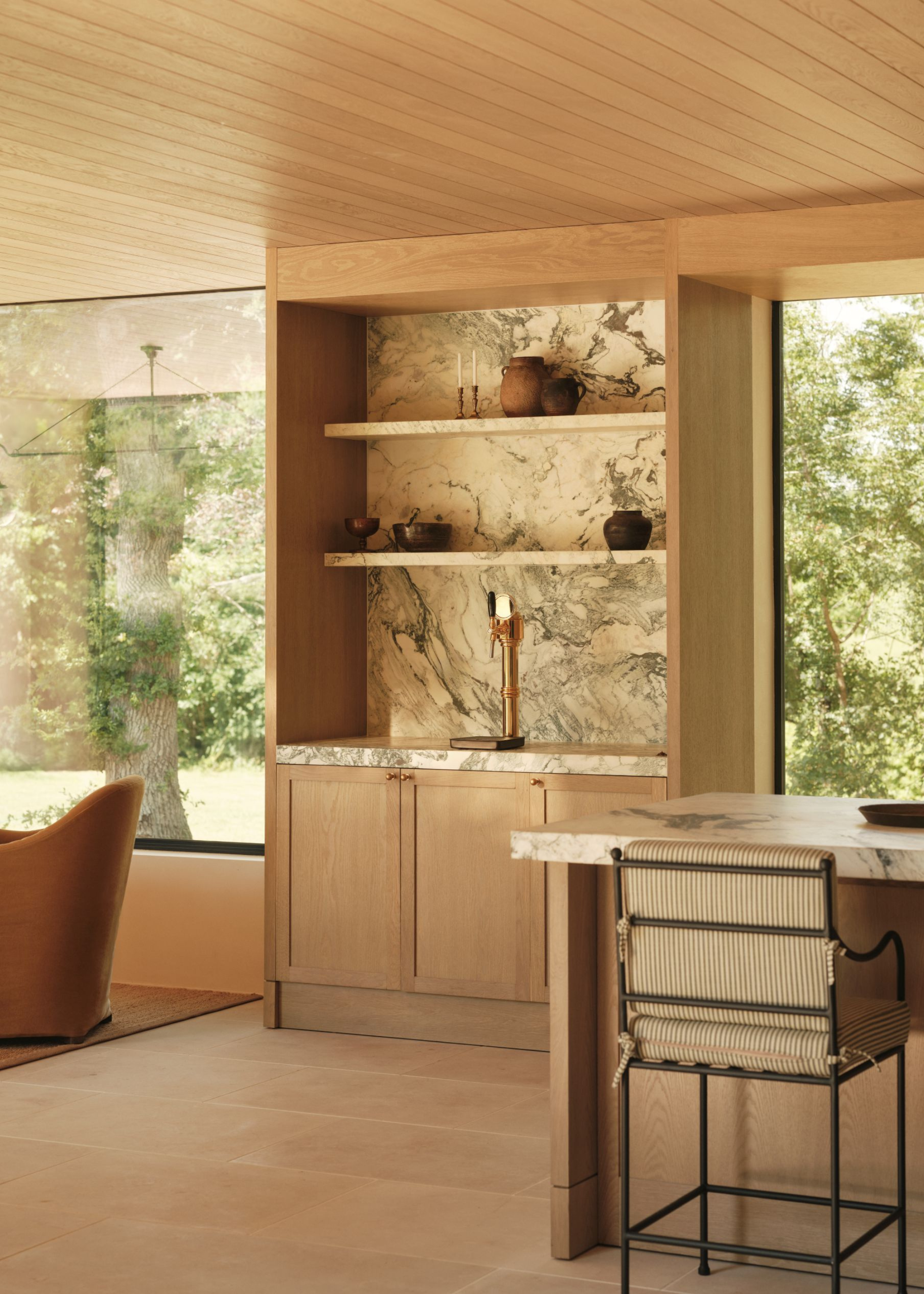 timber clad pool house with small bar area and huge windows