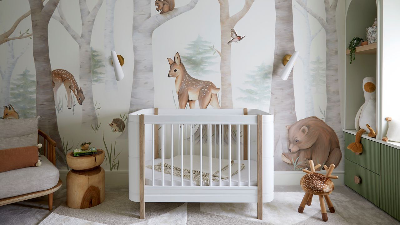 A nursery with a mural on the walls