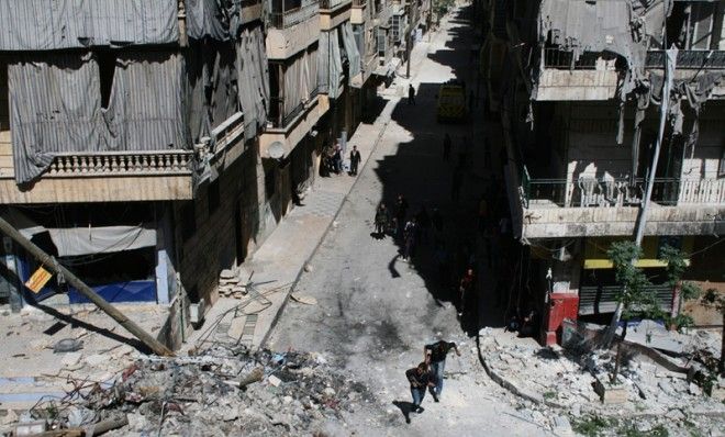 Free Syrian Army fighters run to avoid snipers, April 28.