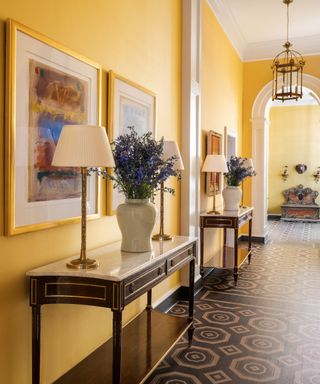 gallery hall with yellow silk wallcovering and painted floor