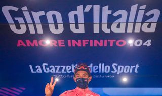 Oveall leader Team Ineos rider Colombias Egan Bernal celebrates on the podium after winning the 16th stage of the Giro dItalia 2021 cycling race 153km between Sacile and Cortina dAmpezzo on May 24 2021 Photo by Luca Bettini AFP Photo by LUCA BETTINIAFP via Getty Images