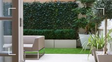 picture of monochrome garden with fake grass and patio slabs