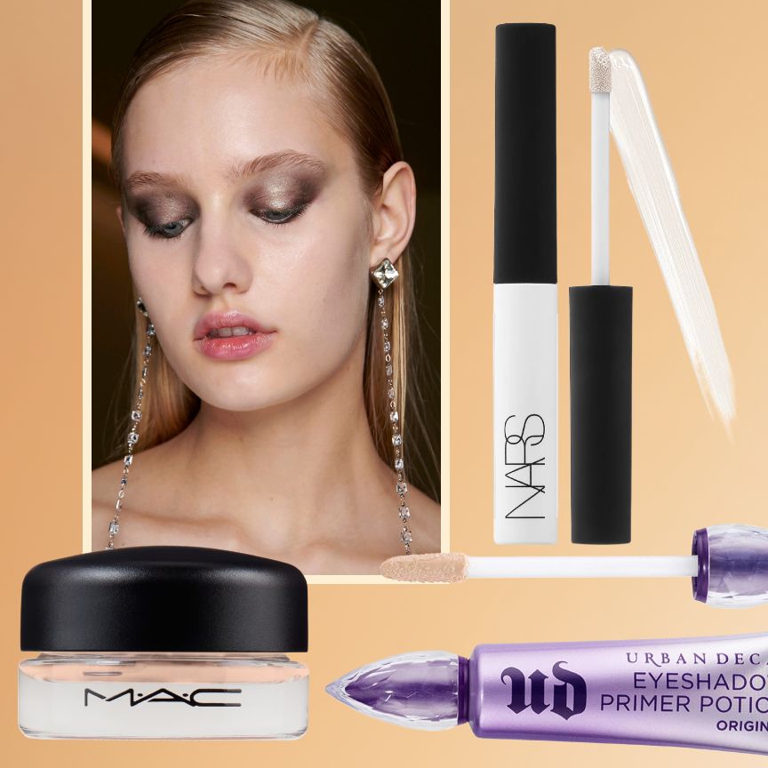 A model faces the camera in a closeup image, the model wears black clothing, a silver necklace and their makeup consists of a claret red lip and soft brown eyeshadow with strong brows and full lashes.