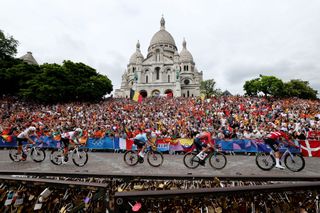 PARIS FRANCE AUGUST 03 LR Juan Ayuso of Team Spain Felix Grossschartner of Team Austria Remco Evenepoel of Team Belgium Attila Valter of Team Hungary and Mads Pedersen of Team Denmark compete passing by the Basilica of the Sacre Coeur while fans cheers during the Mens Road Race on day eight of the Olympic Games Paris 2024 at trocadero on August 03 2024 in Paris France Photo by Alex BroadwayGetty Images