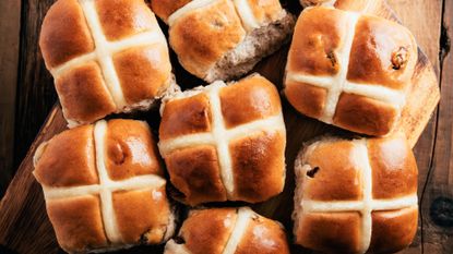 hot cross buns on a wooden countertop