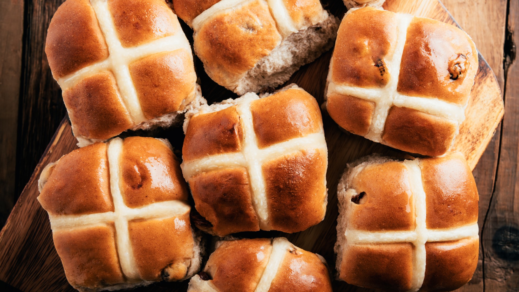 hot cross buns on a wooden countertop