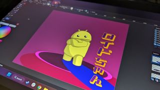 Huion Kamvas Pro 13 2.5K graphics / drawing tablet being used on a wooden table in an office space in the daytime.