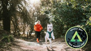 Woman trail running with dog