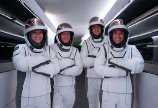 The four astronauts of SpaceX's Polaris Dawn mission pose in spacesuits while rehearsing launch.