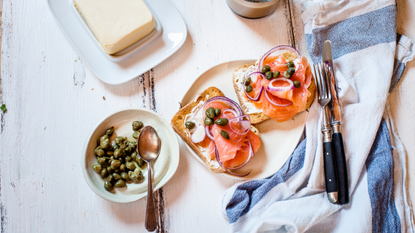 Toast with smoked salmon on table