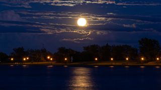 A supermoon rises over the water of Lachine, Montreal, Quebec 