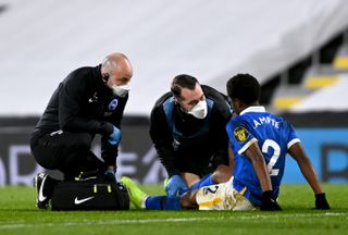 Brighton defender Tariq Lamptey receives medical treatment