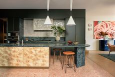 Green kitchen with burl wood cabinet fronts on the kitchen island