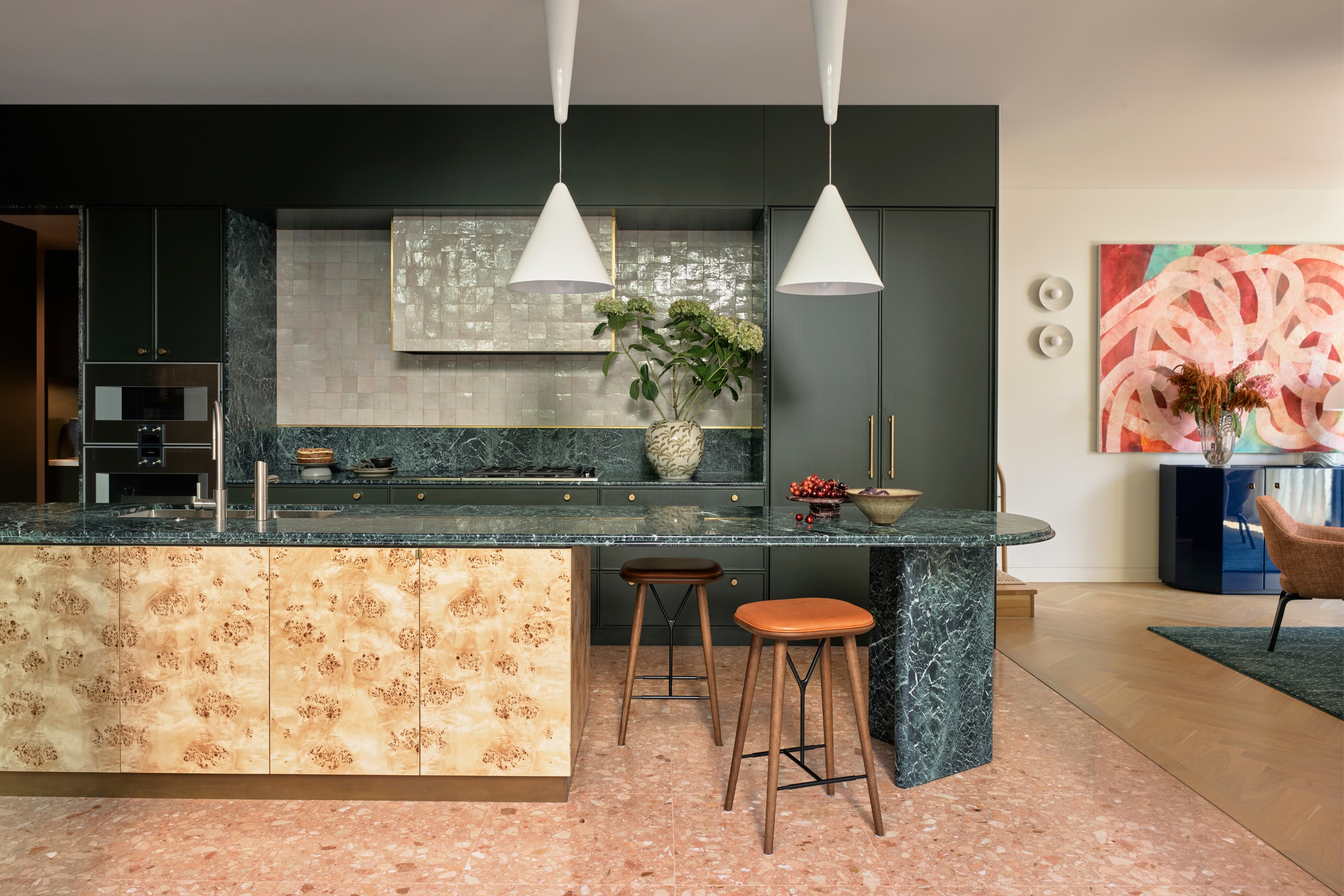 Green kitchen with burl wood cabinet fronts on the kitchen island
