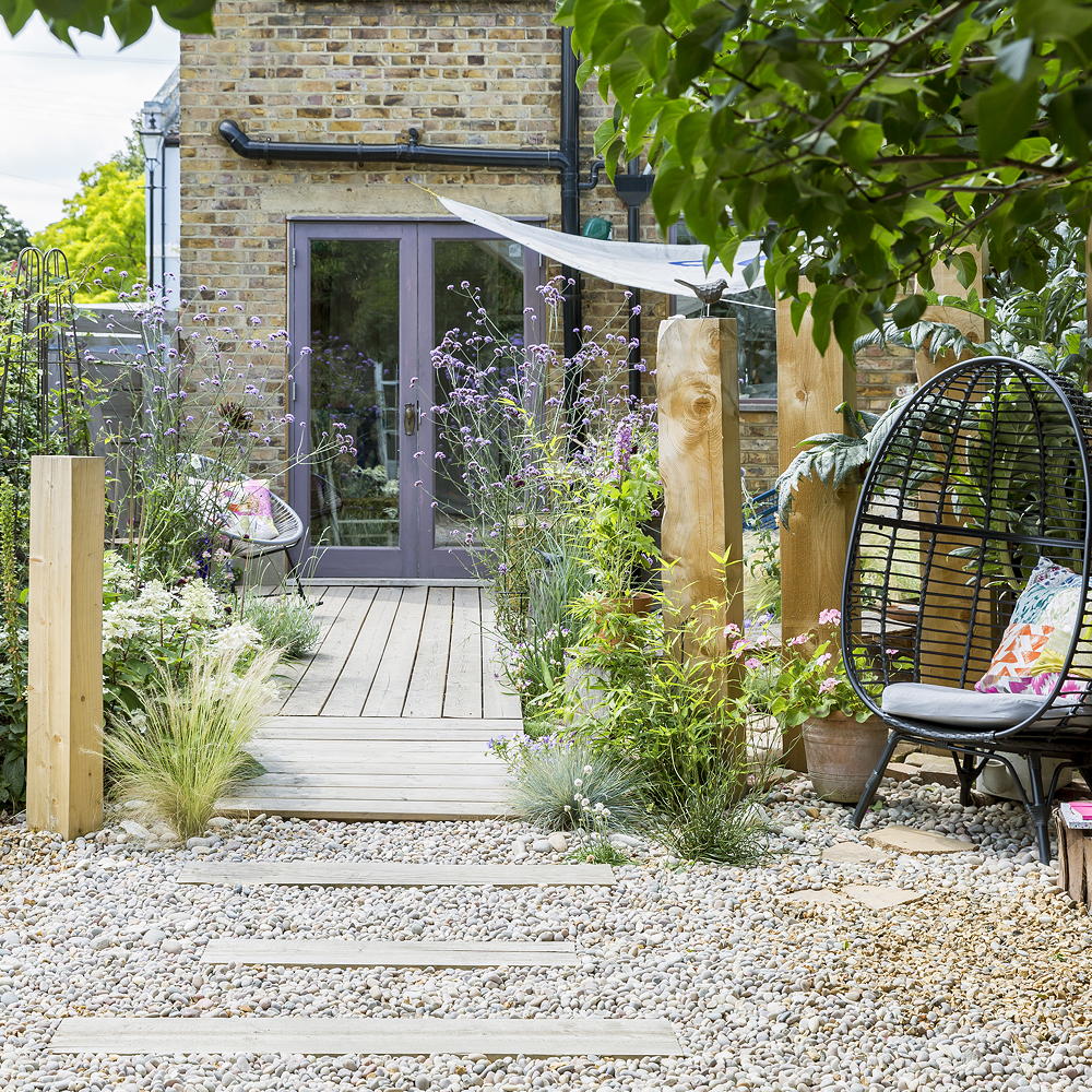 garden decking area with purple door and patio chair