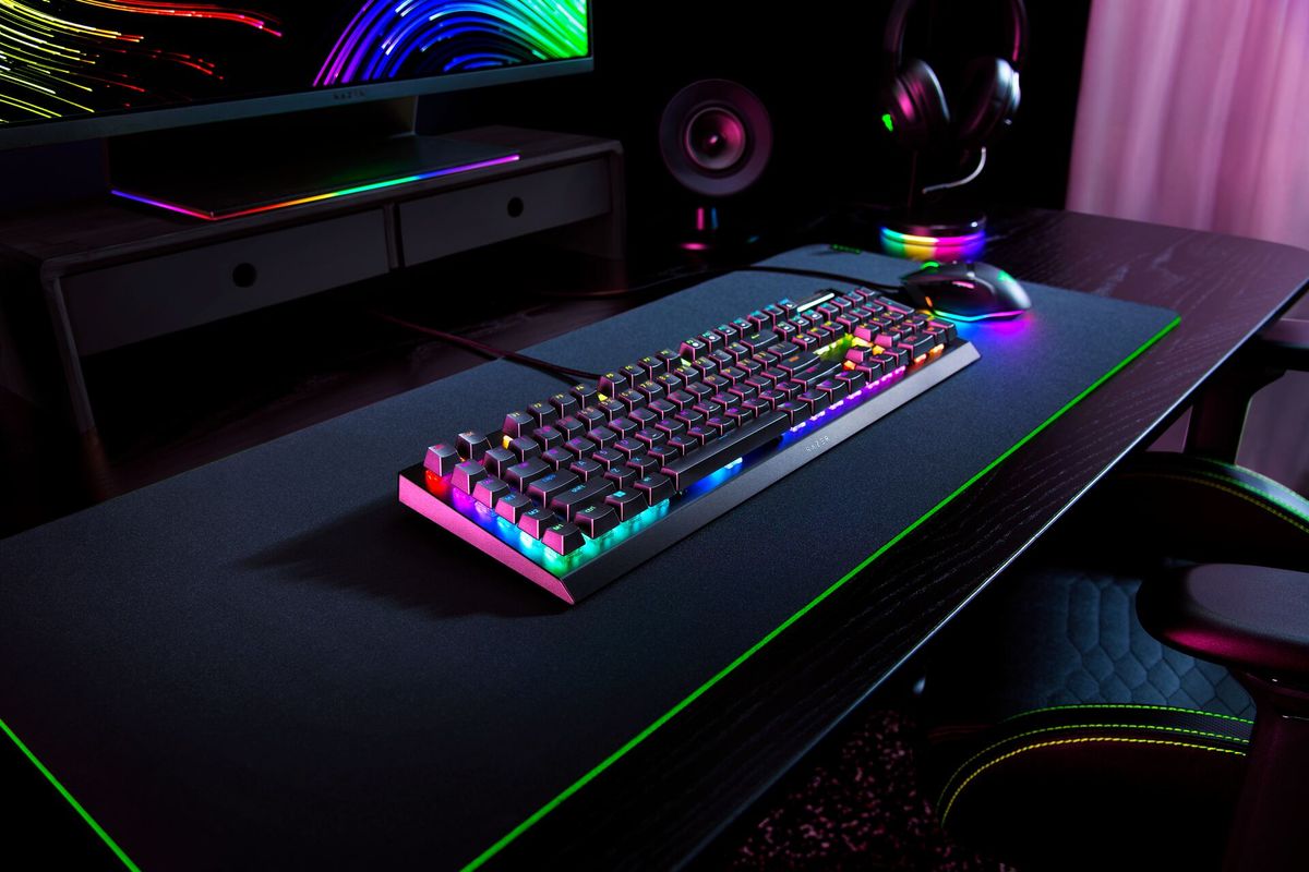 Razer Blackwidow V4 X on desk with other razer products.