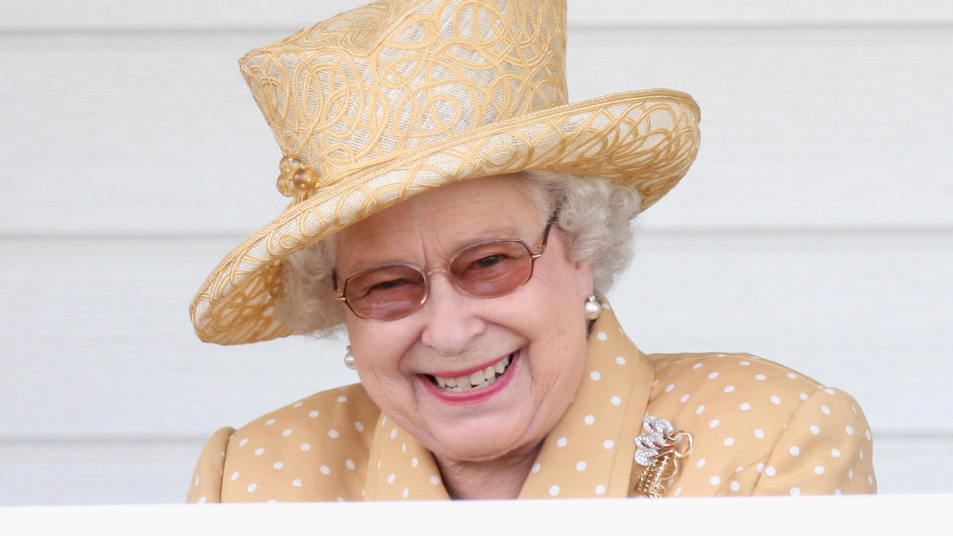 Queen Elizabeth II laughs in the Royal Box as she attends the Queen's Cup final at Guards Polo Club on June 14, 2009
