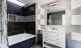 A semi-modern black and white tiled bathroom