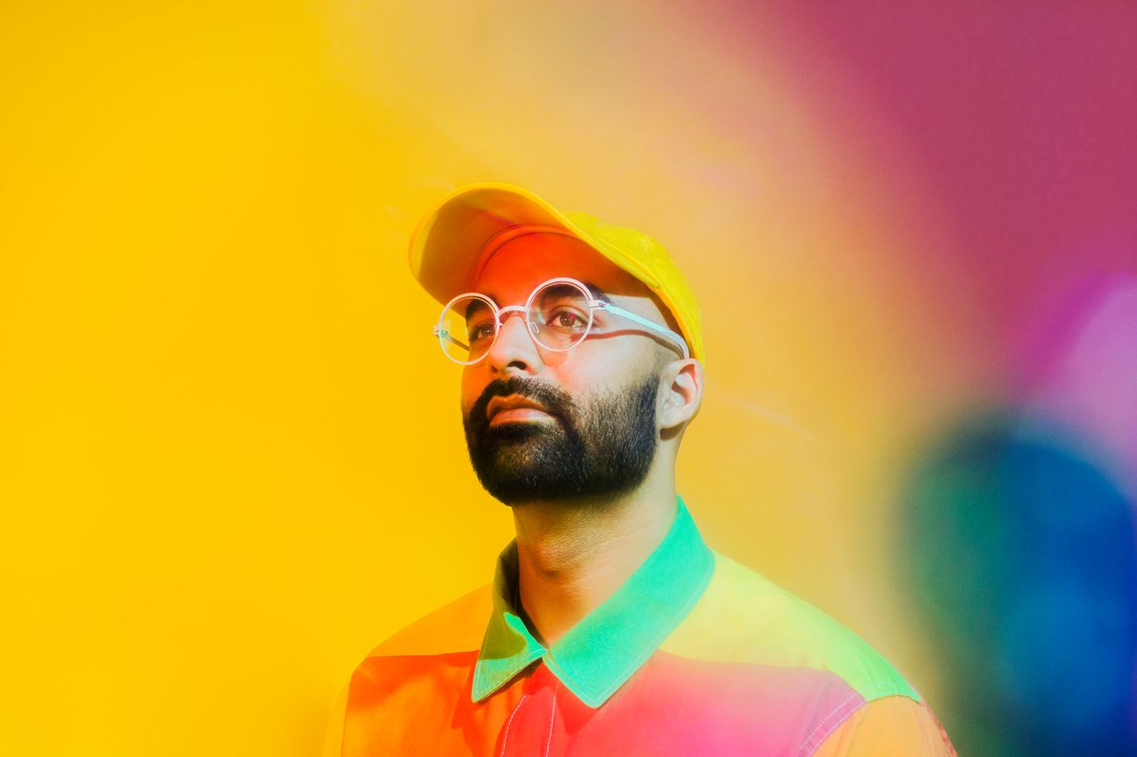 A portrait of Ritesh Gupta on a multicoloured background