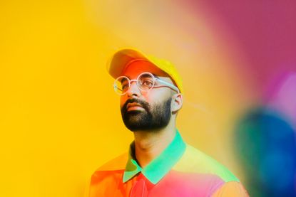 A portrait of Ritesh Gupta on a multicoloured background