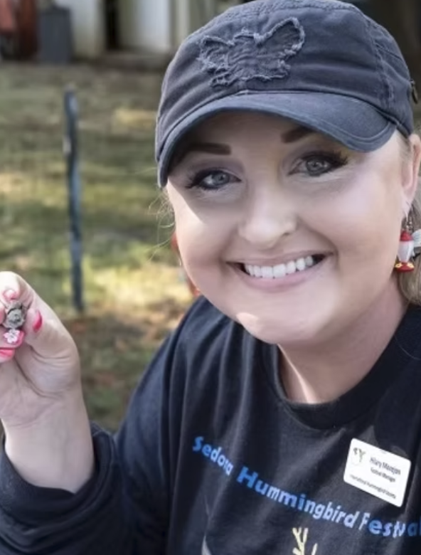Woman wearing blue cap smiling to camera