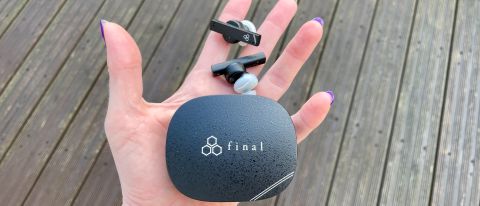 Final ZE8000 MK2 earbuds and case held in a hand on grey background