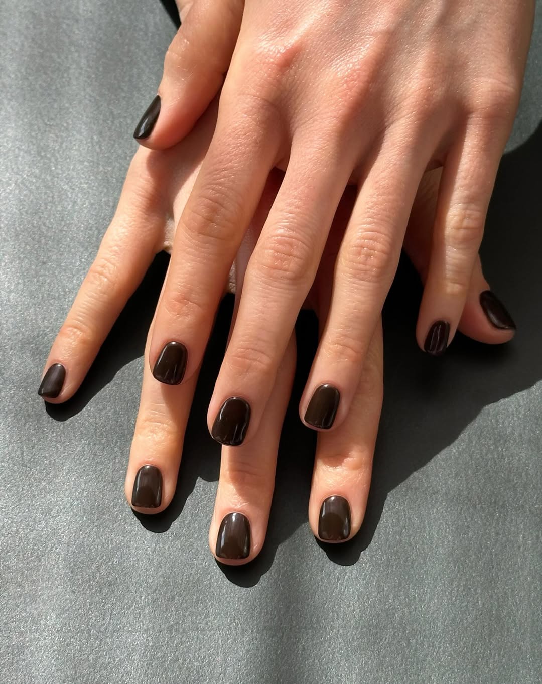 A chocolate manicure on Lily Collins by Imarni Nails