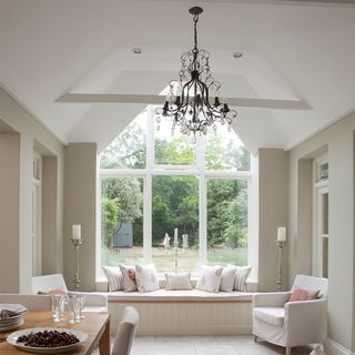 dining area with glass window and chandelier