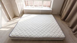 Hybrid mattress is placed on the floor without a suitable base leaving it as risk of damage and mildew